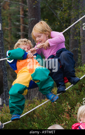 I bambini in un Norvegese naturbarnehage natura vivaio a piedi di corda Foto Stock