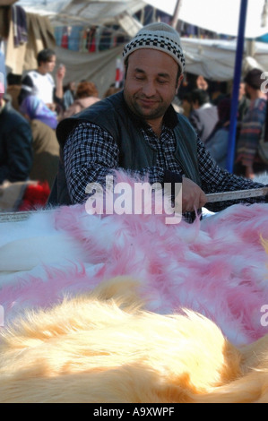 Titolare di stallo la vendita di pellicce nel tessuto del mercato a Kadikoy sulla costa asiatica di Istanbul, Turchia Foto Stock