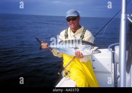 Uomo con piccoli tonni catturati durante la pesca con la mosca al largo della costa della Carolina del Nord USA Modello e Proprietà immagine rilasciata Foto Stock