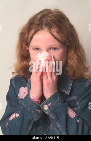 Giovane ragazza soffia il naso Foto Stock