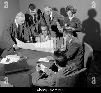 Anni Cinquanta anni sessanta sala conferenze con gli uomini alla ricerca su documenti mentre il segretario prende appunti Foto Stock