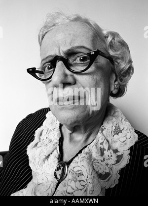Anni sessanta anni settanta ritratto di donna senior di espressioni facciali disapprovando critico significa età geriatrica scorbutico vecchia cameriera GRANNY Foto Stock