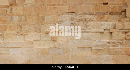 Antico muro di pietra gialla di texture di sfondo di arenaria Foto Stock