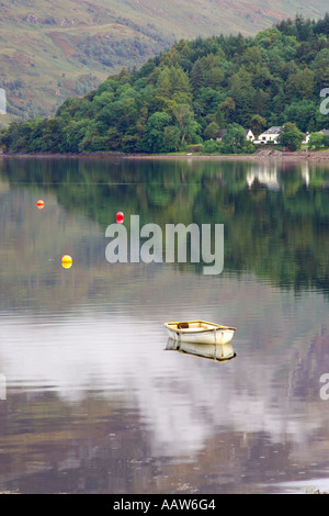 Piccolo gommone ormeggiato sul Loch Leven vicino a Ballachulish Glencoe con tre boe colorate e colline boscose Foto Stock