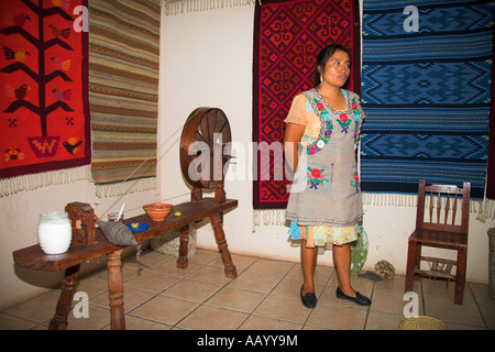 Lady, ruota di filatura utilizzata in fatto a mano la fabbricazione di tappeti, Teotitlan del Valle, vicino a Oaxaca, Stato di Oaxaca, Messico Foto Stock