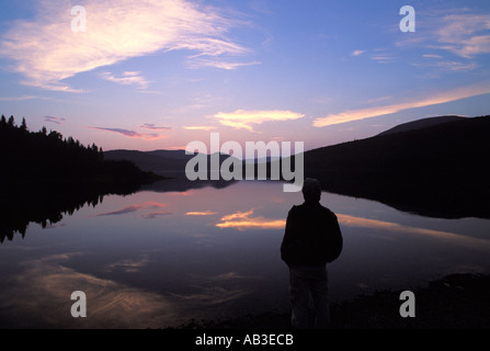 Uomo che guarda nel lago a sunrise Monte Carleton Parco Provinciale New Brunswick Canada Foto Stock