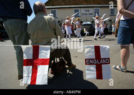 Gli spettatori a guardare Morris dancers in azione al di fuori di un pub, Thaxted, Essex REGNO UNITO 02 03 Maggio 2007 Foto Stock