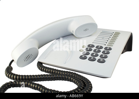 Telefono ufficio con cavo sinuose isolato su bianco. Foto Stock