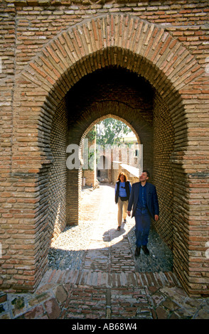 Due turisti di entrare nel Alcanzaba xi secolo il palazzo fortificato della sentenza Mori di Malaga sulla Costa del Sol Spagna Foto Stock