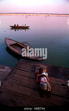 Indian uomo dorme sulle rive del fiume sacro Gange in Banaras Foto Stock