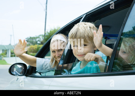 Famiglia sventolare dalle finestre auto Foto Stock