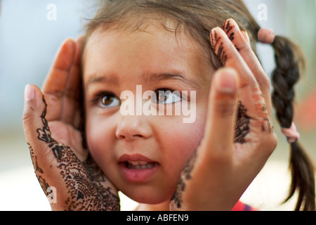 Madre detiene la figlia della faccia nelle sue mani Foto Stock