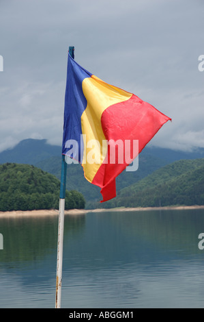 Bandiera rumena in volo da diporto sul lago Vidraru in Romania Foto Stock