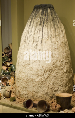 Vecchio forno in ceramica tradizionale con vari pezzi di ceramica argillosa nelle vicinanze in un museo storico. Foto Stock