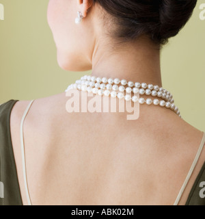 Vista posteriore della donna che indossa collana di perle Foto Stock