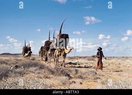 Gabbra donna conduce un cammello in treno attraverso il deserto Chalbi nel nord del Kenya Foto Stock