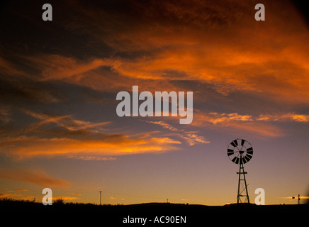 Sunset silhouette di un mulino a vento mancano alcune delle sue lame Sud Africa Foto Stock