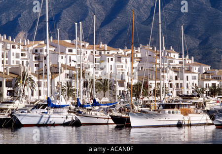 Yacht ormeggiati a Puerto Banus con appartamenti e ville di lusso dietro Costa del Sol Marbella Spagna Foto Stock