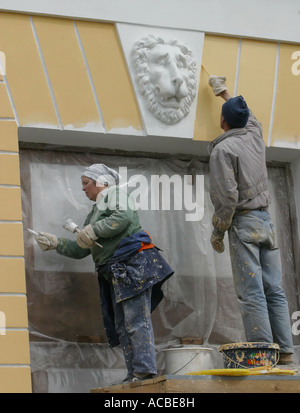 Saint Petersburg, Russia - 22 Maggio 2003 : Nevsky Prospekt. Pittori di ripristinare la facciata della casa. L uomo e la donna muro di casa. Bassorilievo in forma di testa di leone sulla parete. Foto Stock