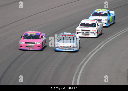 Racing pick up trucks racing attorno ad un circuito rialzata Foto Stock