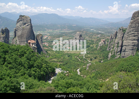 Vista tipica di pinnacoli rocciosi e uno dei tanti monasteri di Meteora regione sopra la città di gateway di Kalambaka Meteora area del Greco Foto Stock