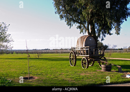 Un vecchio carro trainato da cavalli carrello con un vecchio Barile di legno nel giardino di fronte alla vigna. Bodega Juanico Familia Deicas Cantina Juanico, Canelones, Uruguay Sud America Foto Stock