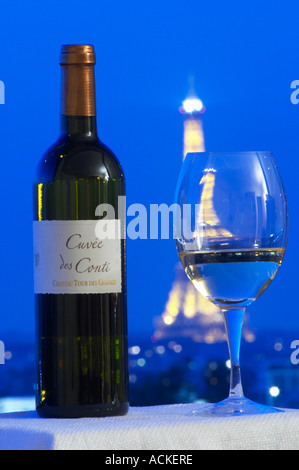 Cuvee des Conti castello Tour des Gendres, Bergerac, contro uno sfondo di una vista su Parigi con cielo blu scuro e illuminato dalla Torre Eiffel e un bicchiere di vino Bergerac Dordogne Francia Foto Stock