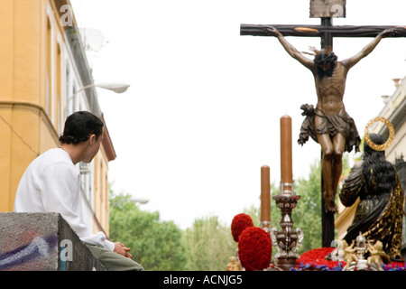 Kid guardando la figura di un Cristo morto, la settimana santa, Siviglia, Spagna, 2006 Foto Stock