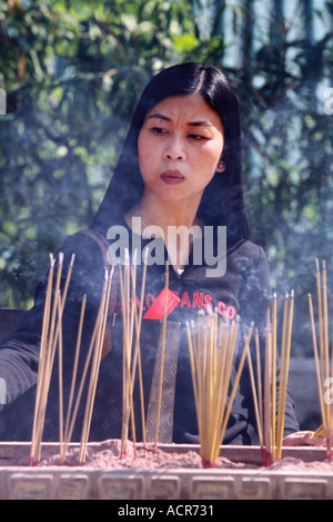 Pregando la Dama con l incenso 7 Wong Tai Sin Temple Kowloon Foto Stock