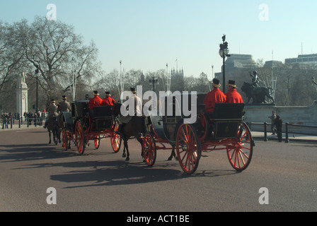 Westminster fuori Buckingham Palace carrozze trainate da cavalli passando il memoriale della Victoria dirigendosi verso il centro commerciale Foto Stock