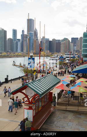 CHICAGO Illinois gente camminare a Navy Pier guardando mappa barche ormeggiate highrise edifici del centro a distanza Foto Stock