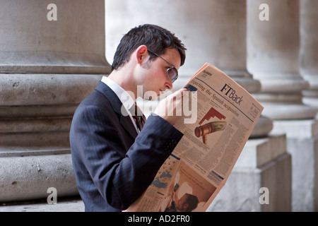 Giovane imprenditore letture Financial Times nella città di Londra Foto Stock