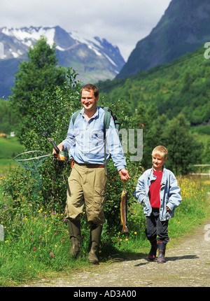 Padre e figlio a passeggio tra i fori di pesca di trote in Norvegia Foto Stock