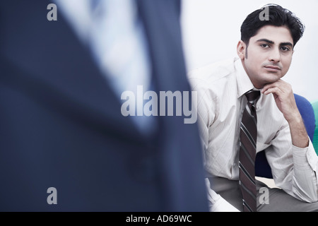 Ritratto di un uomo di affari di pensare con la mano sotto il mento Foto Stock