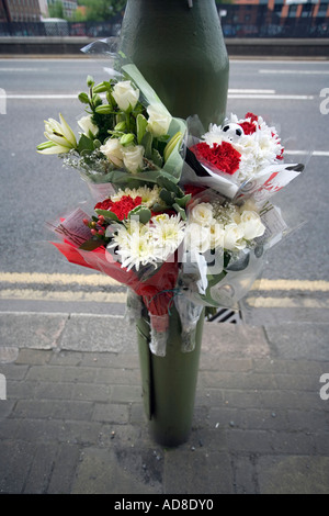 Un omaggio floreale fissato ad una lampada posta sulla scena di un incidente stradale in Birmingham Foto Stock