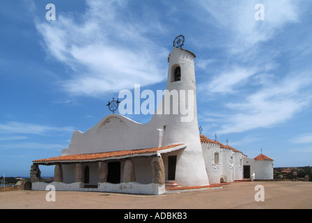 Porto Cervo Stella Maris chiesa bianca tipica architettura italiana mediterranea su cielo azzurro giorno di sole con parte della costa di Smeraldo oltre Foto Stock