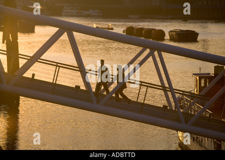 Pedoni camminare su per una rampa da una barca galleggiante bar lungo th Tamigi a Londra Foto Stock