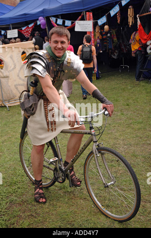 L uomo nel soldato romano costume seduti sulla bici Foto Stock