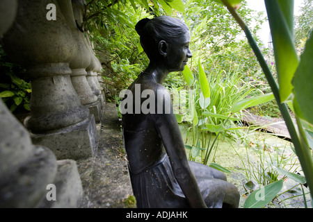 Statua di bronzo di una giovane donna che si affacciava su un laghetto in un giardino ornamentale ad RHS Wisley, Inghilterra Foto Stock