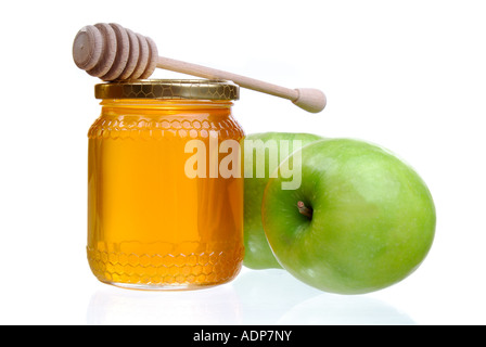 Mele Verdi e un vaso di luce dorata di miele con un bilanciere di miele, simbolico dell'anno Ebraico celebrazioni Rosh Hashanah Foto Stock