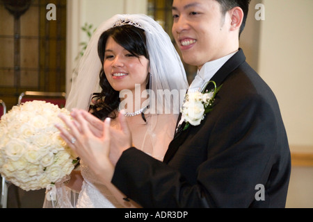 Sposa e lo sposo che mostra le loro fedi sulle loro mani dopo la cerimonia di nozze Foto Stock