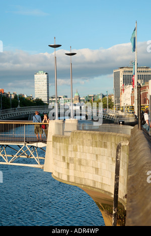 Vista del fiume Liffey con Millennium Bridge e Ha'penny Bridge a Dublino in Irlanda Foto Stock