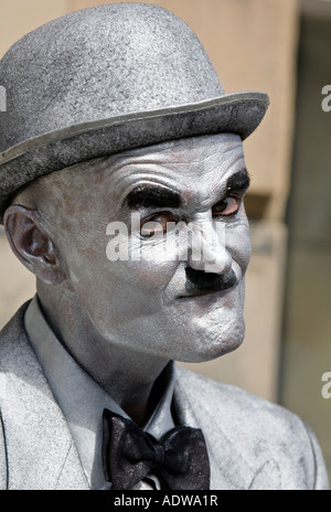 Uomo vestito come un argento Charlie Chaplin statua vivente a Edinburgh Festival Fringe Royal Mile, Scozia. Foto Stock