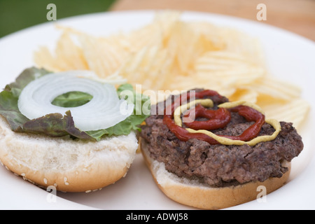 Primo piano di un hamburger su una piastra Foto Stock