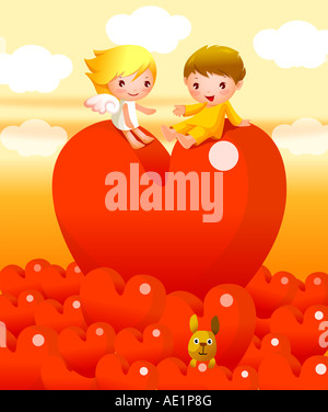 Un ragazzo e una ragazza seduta su un cuore palloncino a forma di Foto Stock
