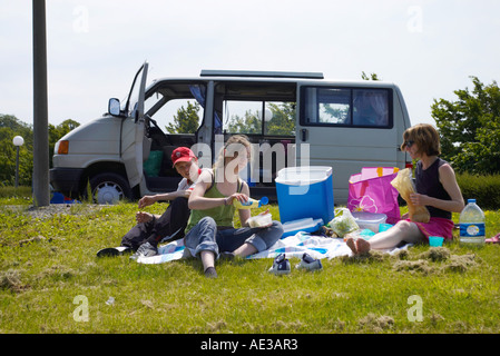 La donna e i suoi figli aventi un picnic da camper in autostrada Aire in Francia Foto Stock