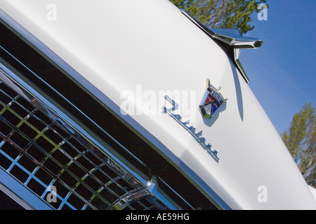 La parte anteriore del cofano di un bianco 1955 Ford Fairlane convertible auto classica con emblema ornamento del cofano e griglia Foto Stock