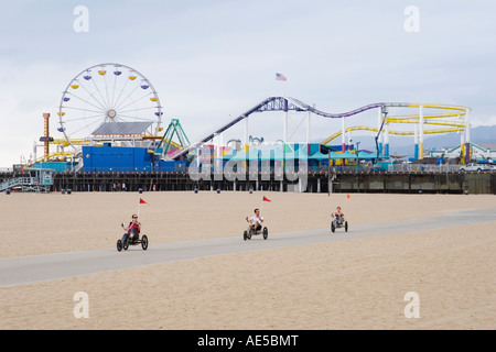 I turisti a cavallo sulla spiaggia in recumbent tricicli a Santa Monica Pier Los Angeles California Foto Stock