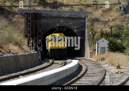 Treno lascia un tunnel in El Chorro stazione ferroviaria in Andalusia Foto Stock