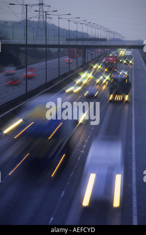 Faro anteriore di percorsi di traffico pesante Viaggiare sulla autostrada M62 al crepuscolo Yorkshire Regno Unito Foto Stock